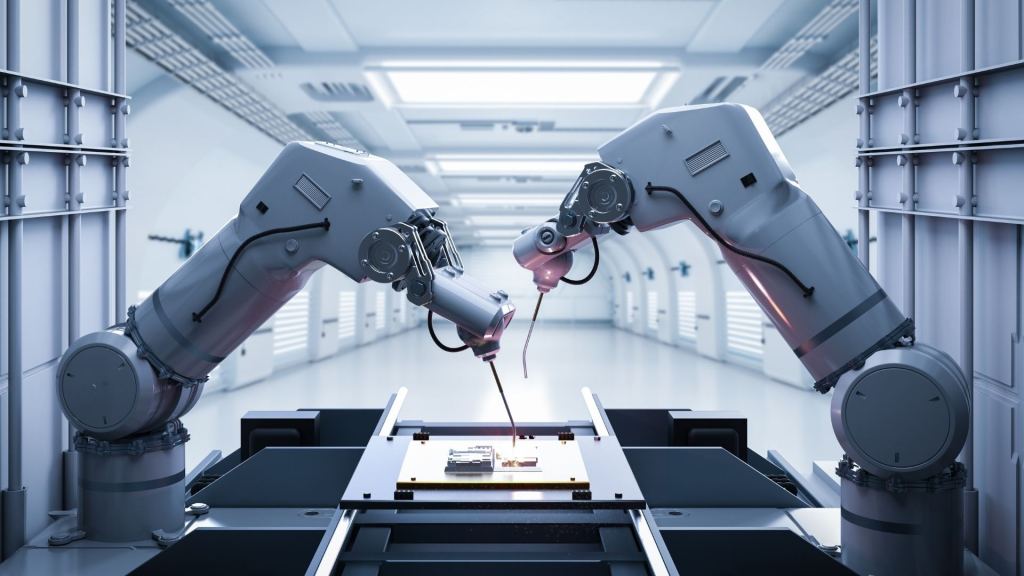 Two industrial robot arms working together on a production line